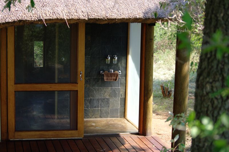 The indoor / outdoor shower in the luxury thatched chalet